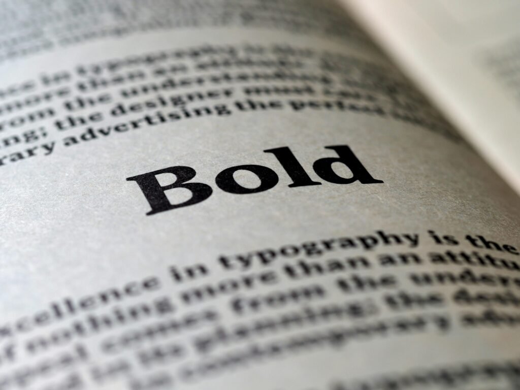 Flex Printing Services In Dubai | Flex Printing Near Me Focused image of the word 'Bold' in typography on a book page.